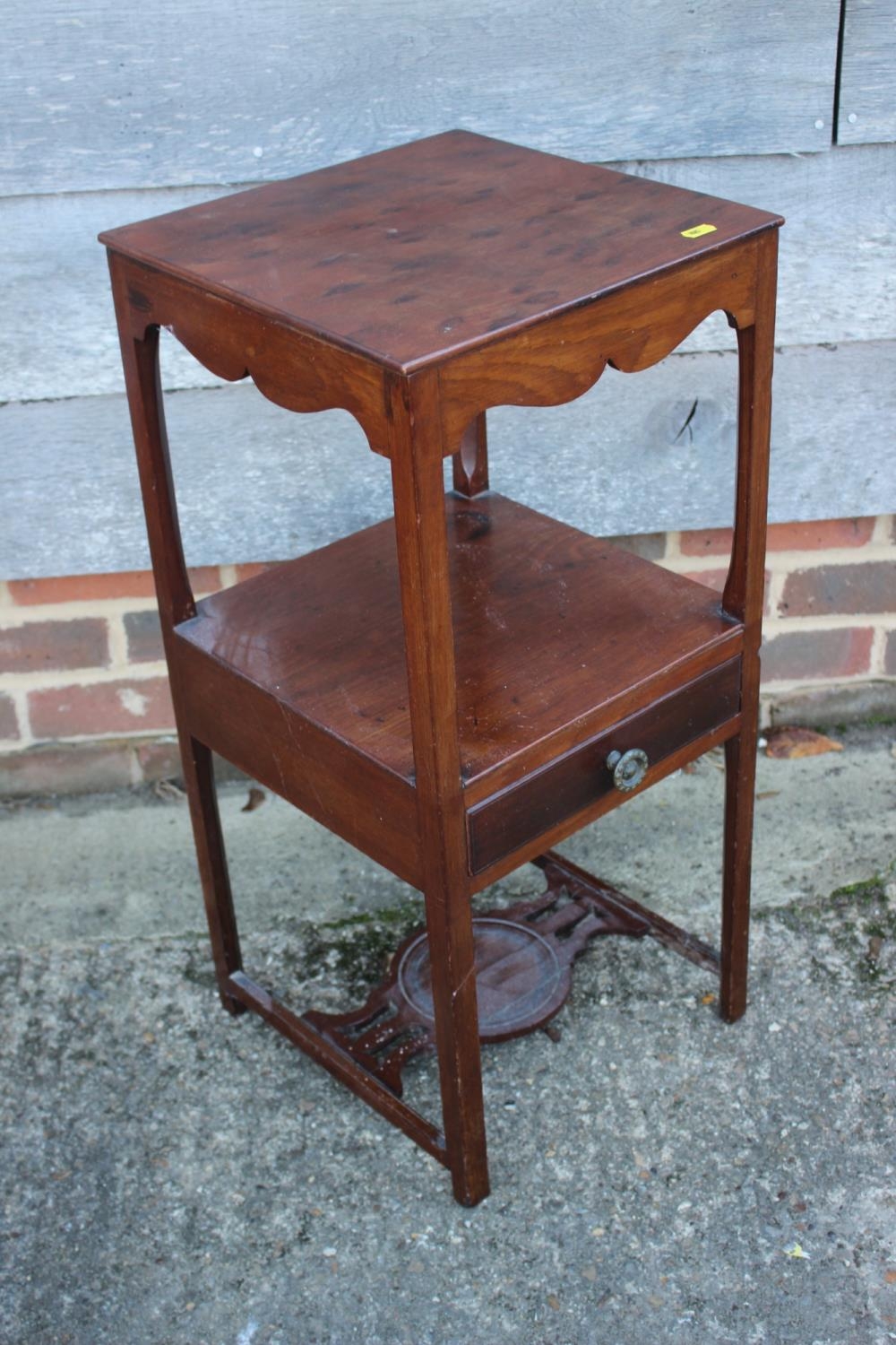 A plum pudding mahogany three-tier wash stand, fitted one drawer, on chamfered supports, 13"