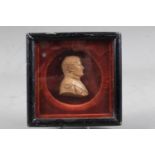 A 19th century wax portrait of Napoleon, 2 3/4" high, in velvet lined ebonised frame