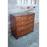 A Georgian mahogany bowfront chest of two short and three long graduated drawers with brass ring