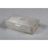 A silver cigarette box with engine turned decoration, 6" wide