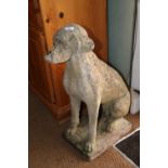 A cast stone figure of a seated hound, 28" high