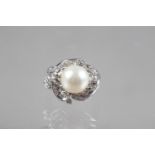 A white metal, diamond and pearl dress ring, stamped 18k, size L, 6g