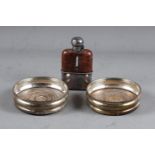A pair of silver wine bottle coasters and a silver plated and leather mounted hip flask