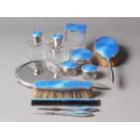 A silver and blue guilloche enamel dressing table set, comprising a mirror, two brushes, a pair of