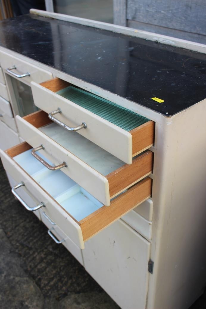 A dentist's instrument cabinet with black glass top, fitted fifteen drawers, central glazed cupboard - Bild 3 aus 7