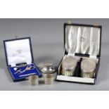 A pair of silver napkin rings, a silver inkwell with clear glass liner, a boxed white metal sewing