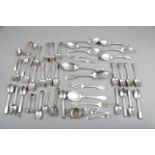 An assortment of loose silver cutlery, including tablespoons, sugar tongs, salt spoons, teaspoons,