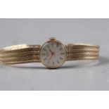 A lady's Longines 9ct gold bracelet watch with silvered dial and baton numerals, 20.8g overall