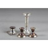 A pair of silver squat candlesticks, 2 3/4" high, a silver trumpet vase with weighted base, 6 1/2"