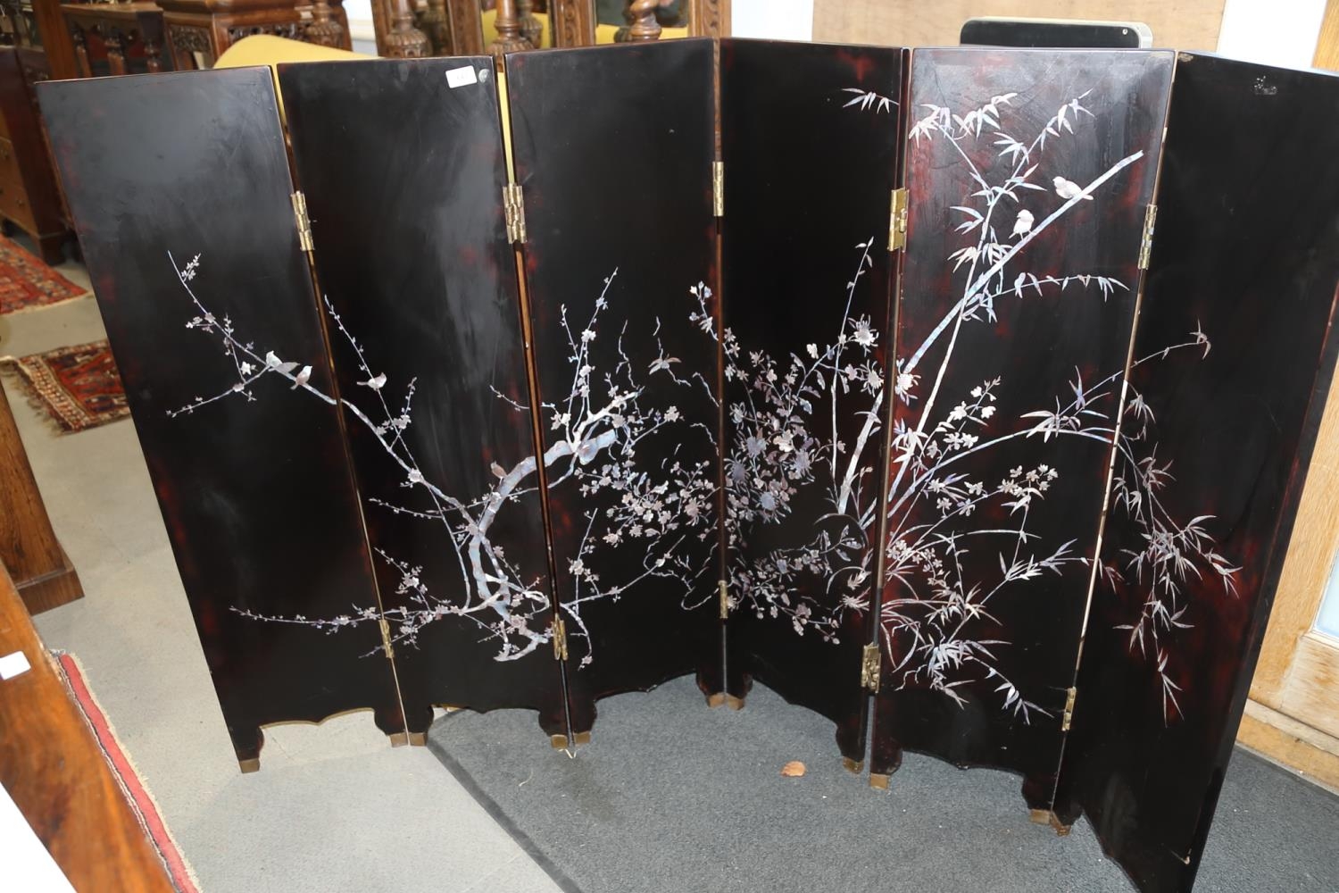 A six-fold lacquered and mother-of-pearl inlaid screen with bird and bamboo design and goldfish