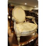A Louis XVI design carved and painted hardwood open armchair with cameo back, on turned and tapering