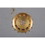 A yellow metal circular brooch, set seed pearls and single diamond, 15.5g gross