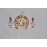 A yellow metal horseshoe pendant, stamped 14k, 2.6g, and a pair of 9ct gold clips, 1.8g