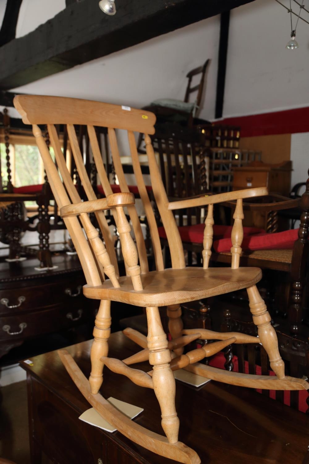 A beech lath back farmhouse elbow rocking chair