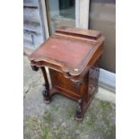 A 19th century figured walnut Davenport desk with stationary compartment over writing slope and four