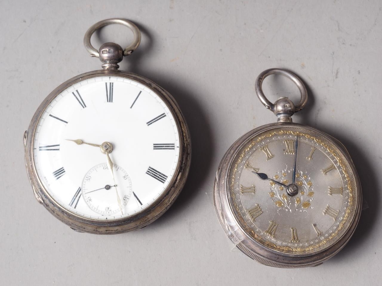 A silver cased open faced pocket watch with silvered dial and Roman numerals, and another similar