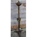 An Edwardian brass adjustable oil standard lamp with swag decoration, on triform base (now converted