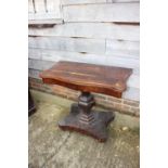 A mid Victorian rosewood serpentine front fold-over top tea table, on shaped column and quatreform