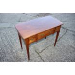 A 19th century mahogany lowboy, fitted one shallow and two deep flanking drawers, on square taper