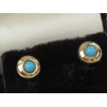 A pair of turquoise stud earrings, no apparent hallmarks, with butterfly backs.