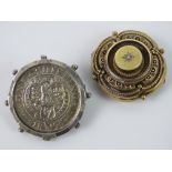 A late Victorian mourning brooch having glazed locket verso,