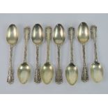 A set of eight HM silver teaspoons having scrollwork border and clamshell pattern handle,
