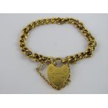 A 9ct gold curb link child's charm bracelet having heart padlock clasp, hallmarked 375, 5g.