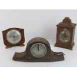 Three assorted wooden cased mantle clocks.