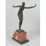 A contemporary bronze in the Art Deco style of a dancer raised over stepped marble base,