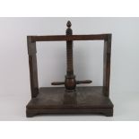 A 19th century mahogany book press, with helix and two handles, acorn finial top, 35.