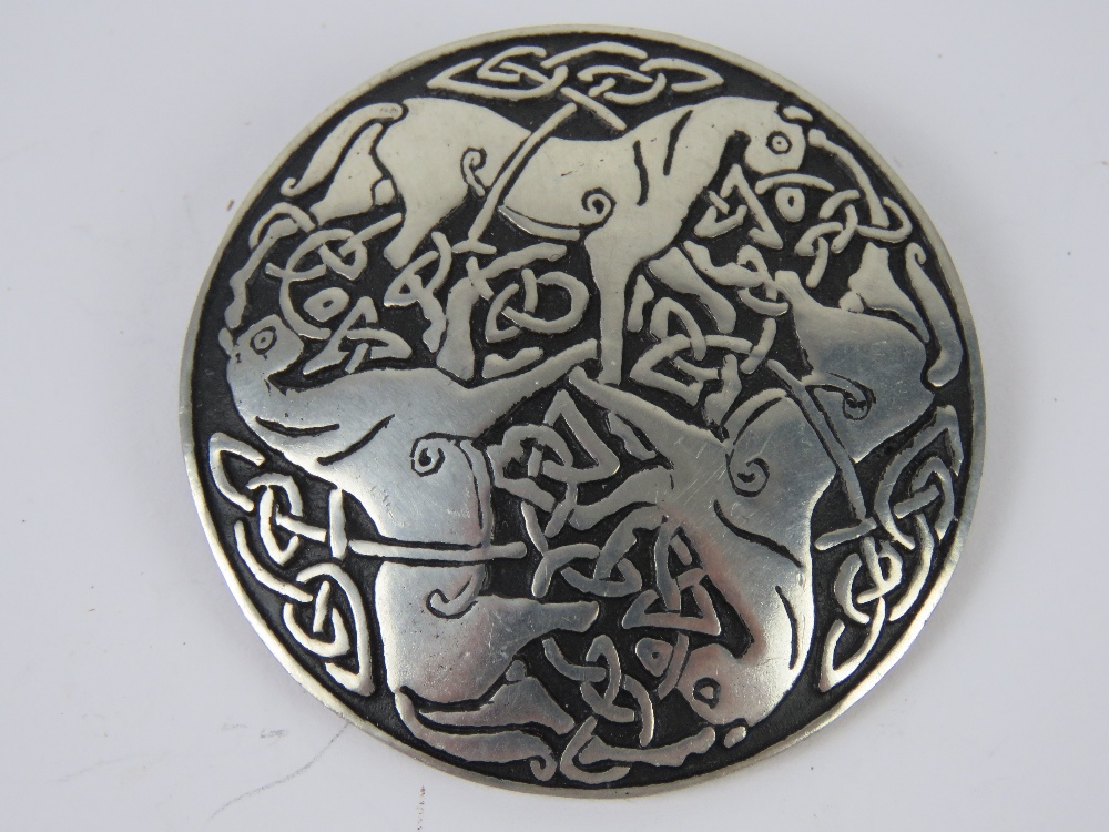 A St. Justin pewter brooch having three horses and Celtic knot design upon, 5.2cm dia.