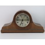 A c1930s Napoleon hat mantle clock having silvered dial with Roman numerals,