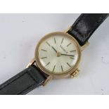 A 9ct gold Ladies Tissot wristwatch, manual, silvered dial, hallmarked 375, case back weighing 1.7g.