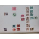 Stamps - A cased album containing Victorian lilac, Penny Reds , green octagonal , Poached Egg , Kg5,