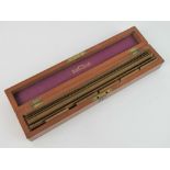 A mahogany box containing a quantity of Stanley's Engine Divided Scale boxwood rulers,