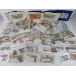 A large quantity of assorted world coins and bank notes including WWII period for Burma, Algeria,
