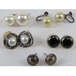 A pair of silver and pearl stud earrings together with two other pairs of silver earrings and two