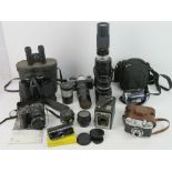 A quantity of assorted vintage cameras and binoculars.