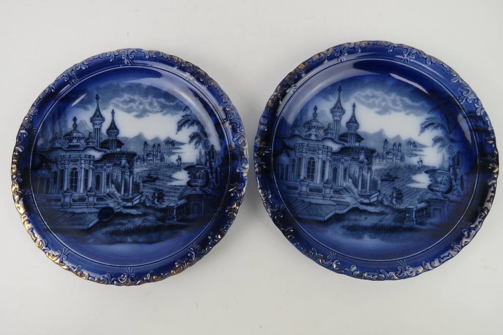 A good pair of blue and white part gilded scenic cabinet plates, un-named, 27cm dia.