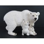 A large contemporary figurine of a polar bear with two cubs, approx 34cm in length.