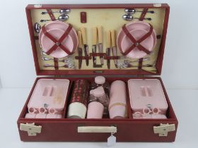 A large Brexton picnic case as retailed by Harrods, opening to reveal mostly full contents within.
