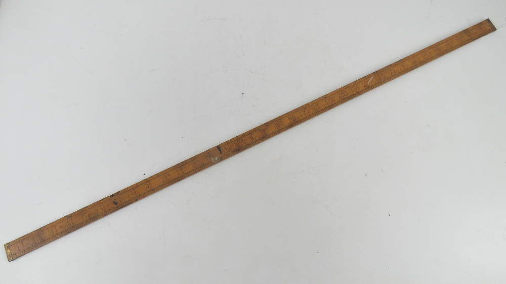 A boxwood yard stick having brass ends made by E Preston & Sons Birmingham.