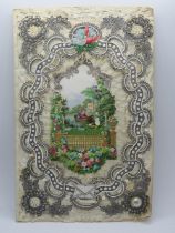 A Victorian decoupage Sweetheart or Valentines card, having lovers in central arch top lake scene,