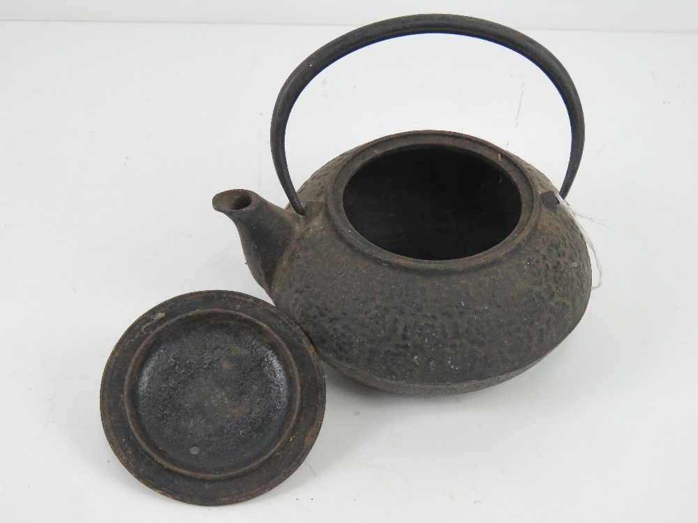 An oriental cast iron teapot having raised floral decoration upon, swing handle, - Image 2 of 5