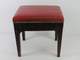 A footstool upholstered in red leather 37 x 32 x 34cm.