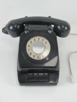 A vintage office extension/transfer rotary telephone in black.