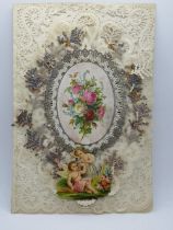 A decoupage Sweetheart or Valentines card having central floral motif and cherubs over paperlace,