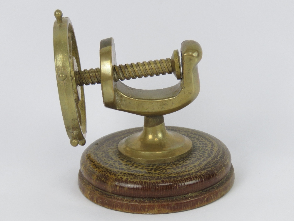 A brass nut cracker in the form of a ship's wheel. - Image 2 of 3