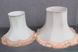 A graduated pair of pale green fabric lamp shades, 58cm dia and 45cm dia respectively.