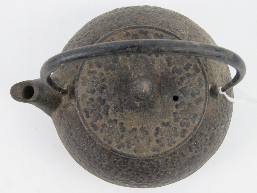 An oriental cast iron teapot having raised floral decoration upon, swing handle, - Image 3 of 5